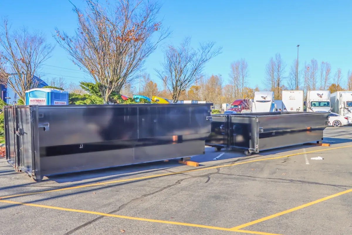 Professional dumpster rental service with roll-off container on residential driveway in Sugarland Run